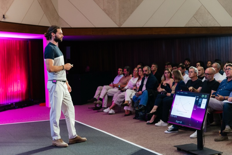 Rui on stage addressing a seated audience